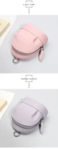 Detail of mini leather coin purses in light pink and purple with silver zippers