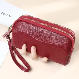 Burgundy pebbled leather clutch wallet with dual zippers and wristlet strap for women