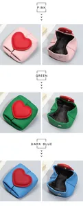 Detailed view of genuine leather heart-shaped wallets in pink, green, and dark blue colors