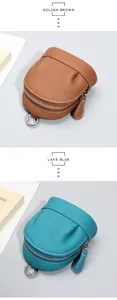 Detailed view of leather mini coin purses in golden brown and lake blue with silver rings