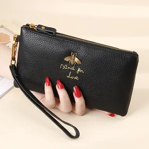 Black pebbled leather wristlet wallet with gold bee emblem and Blind for Love motif
