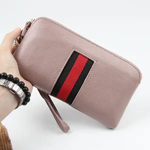 Pebbled leather long clutch wallet in dusty pink with striped ribbon and wristlet strap
