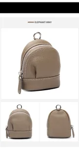 Detail view of elephant gray lychee grain leather mini bag with white stitching and zipper