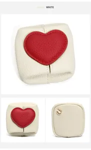 Detail of white lychee grain leather mini coin purse with red heart and gold metal ring