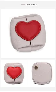 Detailed view of light purple leather coin purse with red heart and gold metal ring
