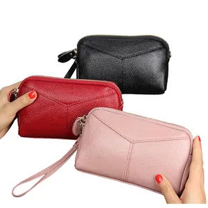 Minimalist leather clutch bags for women with pebble grain texture and wrist straps