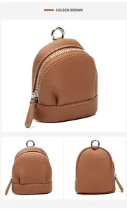 Macro detail of golden brown pebble grain leather mini coin purse with white stitching