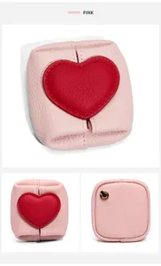 Pink pebble-grain leather coin purse with red heart patch and metal loop detail