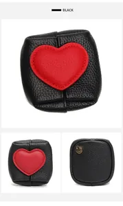 Detail of mini black leather coin purse with red heart patch and metal keychain hook