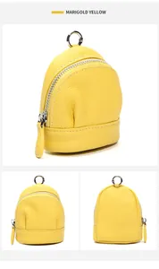 Macro detail of marigold yellow leather mini purse with silver zipper and spring hook
