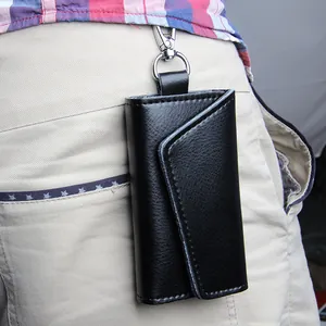 Men's black lychee leather key pouch with silver metal clip worn on waist belt loop