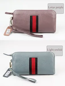 Detail of genuine cowhide wallets in lotus purple and light blue with striped ribbon