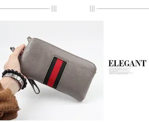 Detail of grey pebbled leather long wallet featuring iconic red and black stripe decoration