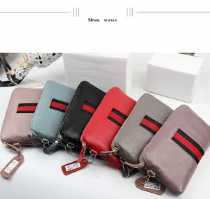 Detailed macro view of litchi grain leather texture on multi-color luxury zip wallets