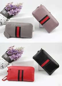 Detailed macro view of four leather wallets with textured finish and iconic striped webbing