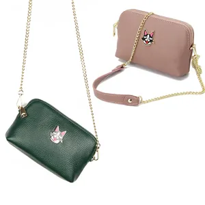 Genuine leather crossbody bag with cartoon dog badge in forest green and dusty pink tones