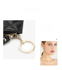 Detail of quilted sheepskin leather bag with elegant golden ring and zip closure