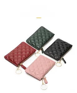 Top view of four sheepskin quilted coin purses in green, burgundy, black, and pink colors
