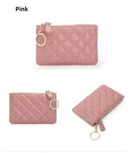 Detail view of pink quilted sheepskin coin purse with gold zipper and keychain ring