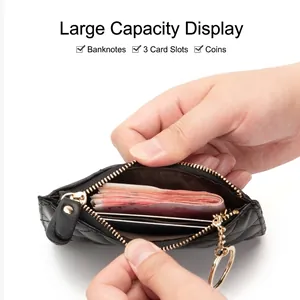 Black quilted sheepskin key pouch with gold zipper showing large capacity interior storage