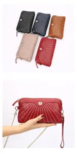 Macro view of stitching details and flower buckle on leather chain shoulder bag