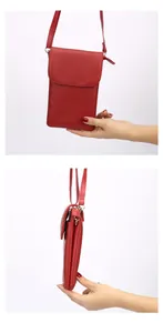 Detail view of red lychee grain leather mini phone bag with multiple zipper compartments