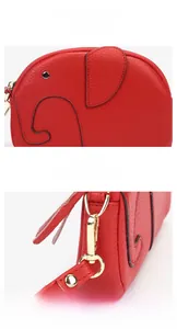 Macro shot of red pebble leather elephant wallet with gold metal zipper and wristlet hook