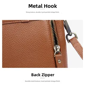 Detail of vintage bronze metal hook and rear zipper on brown lychee grain leather bag