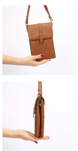 Detail view of brown pebbled leather phone bag showing texture and side metal buckle