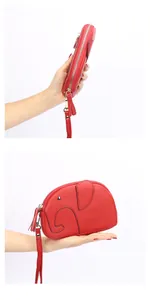 Close-up of red elephant-shaped leather wallet with litchi grain and silver zipper