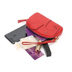 Red elephant leather wristlet wallet showing capacity for phone, cards, and lipstick