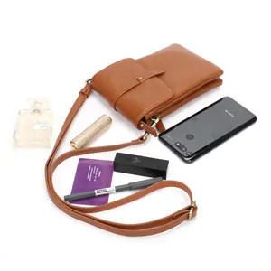 Brown litchi grain leather crossbody bag showing daily capacity with accessories