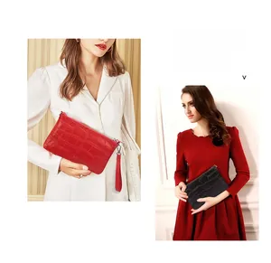 Details von roten und schwarzen Clutch-Taschen aus Krokodilleder mit Metall-Reißverschluss