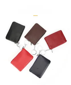 Close-up of small leather coin purses in five colors with litchi grain and key rings