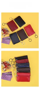 Detail view of multi-color genuine leather wallets with lychee texture and metal keychains