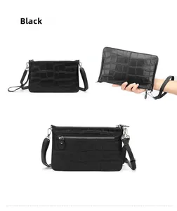 Details einer schwarzen Handtasche mit Krokodillederprägung, Silber-Reißverschluss