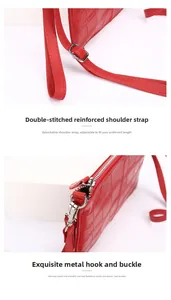 Detail einer roten Krokodil-Leder-Tasche mit silbernen Metallhaken und verstärkten Nähten
