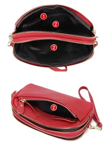 Detail of red pebbled leather wallet showing multi-layer zipper compartments and inner pockets