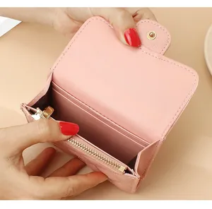 Detailed interior of pink quilted leather wallet with gold zipper and card slots