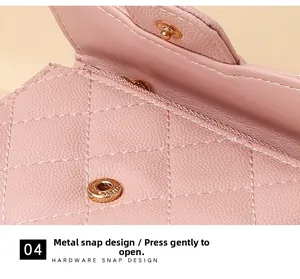 Detail of pink quilted pebble leather wallet featuring a durable golden hardware snap button