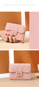 Detailed view of pink quilted leather texture and golden metal buckle on women wallet
