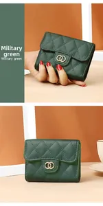 Detail of military green leather wallet featuring quilted stitching and golden buckle
