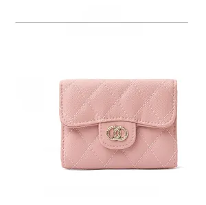 Detailed front view of pink quilted leather short wallet with golden double ring metal clasp