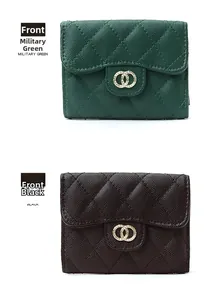 Detail of quilted leather wallets in military green and black with gold hardware