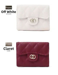 Front view of quilted leather wallets in off-white and claret with gold ring hardware