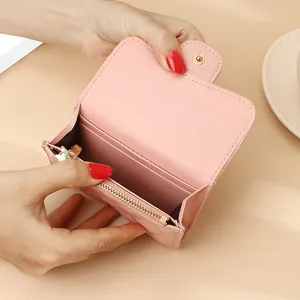 Pink quilted leather small wallet with gold zipper and card slots shown open