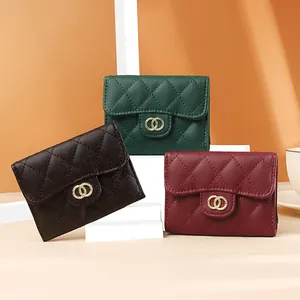 Short quilted leather wallets in black, green, and red with gold hardware detail