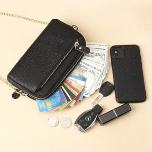 Minimalist black lychee leather crossbody phone bag with gold chain and dual zippers