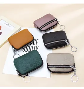 Close-up of five colorful genuine leather coin purses with dual zippers and keyrings