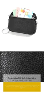 Close-up of pebble grain genuine leather texture on a black coin purse with metal zipper